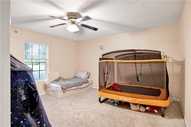 8717 Louis Poiroux Rd N, Theodore, AL 36582 - bedroom with carpet floors, a ceiling fan, a textured ceiling, and baseboards