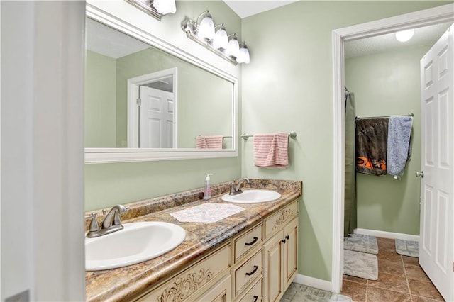 8717 Louis Poiroux Rd N, Theodore, AL 36582 - bathroom featuring double vanity and baseboards
