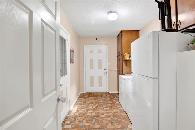 8717 Louis Poiroux Rd N, Theodore, AL 36582 - laundry room featuring light stone finish flooring, cabinet space, washer and clothes dryer, a textured ceiling, and baseboards