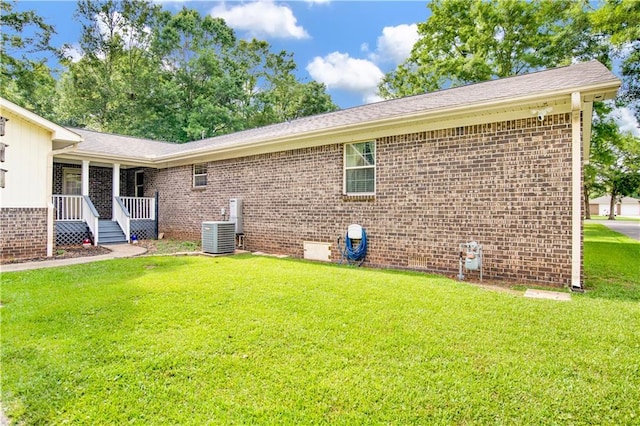 8717 Louis Poiroux Rd N, Theodore, AL 36582 - view of property exterior featuring a yard, brick siding, and central AC unit