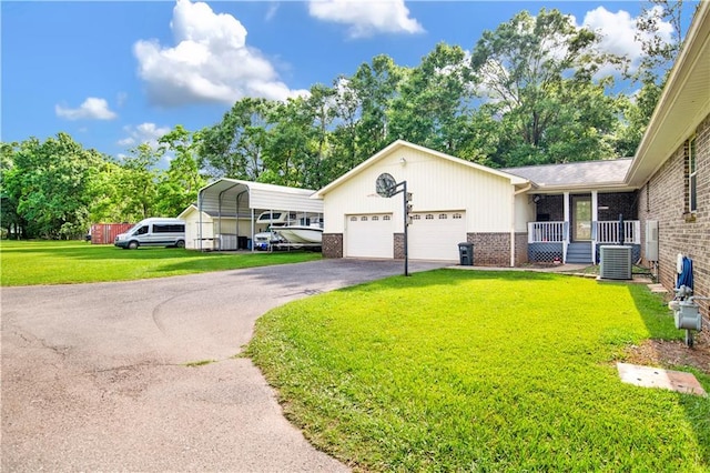 8717 Louis Poiroux Rd N, Theodore, AL 36582 - view of front of house with brick siding, a front lawn, driveway, and a garage