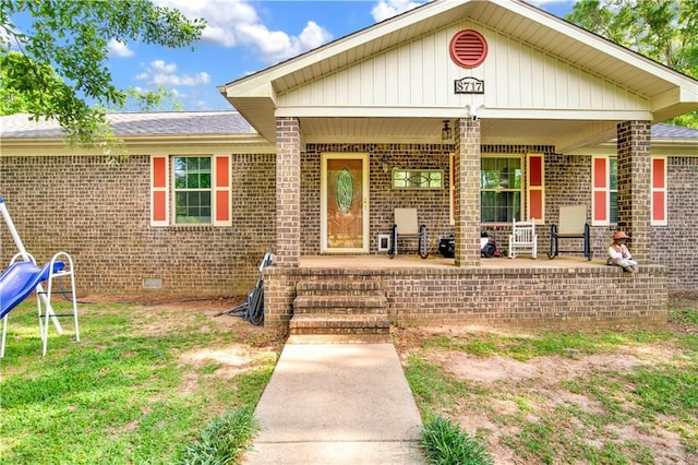 8717 Louis Poiroux Rd N, Theodore, AL 36582 - view of exterior entry with covered porch, brick siding, and crawl space