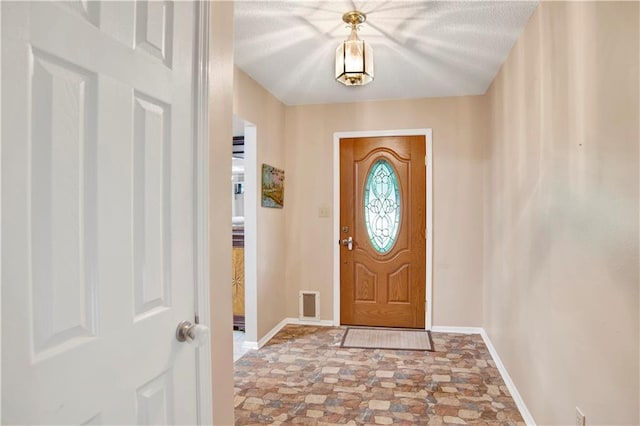 8717 Louis Poiroux Rd N, Theodore, AL 36582 - foyer featuring baseboards and stone finish floors