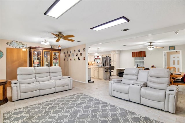 8717 Louis Poiroux Rd N, Theodore, AL 36582 - living area with a ceiling fan and light tile patterned floors