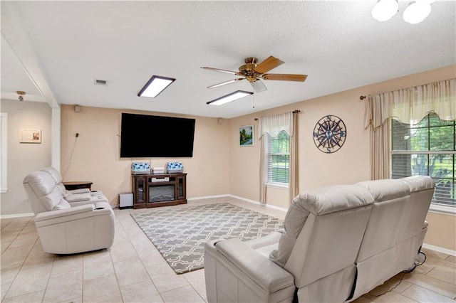 8717 Louis Poiroux Rd N, Theodore, AL 36582 - living area featuring healthy amount of natural light, a ceiling fan, and baseboards