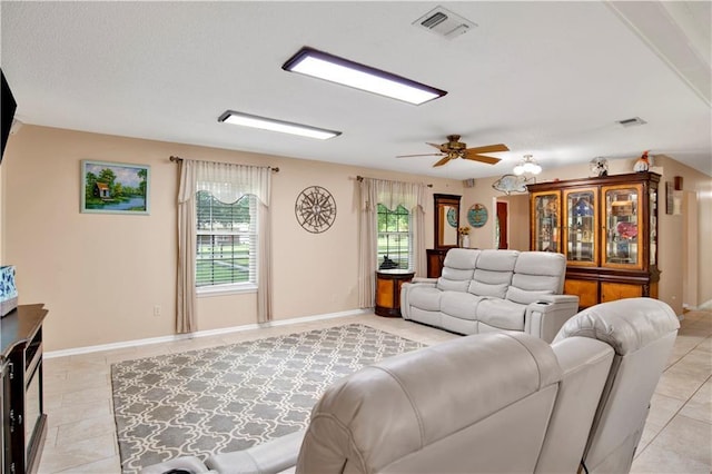 8717 Louis Poiroux Rd N, Theodore, AL 36582 - living room with light tile patterned floors, ceiling fan, and baseboards