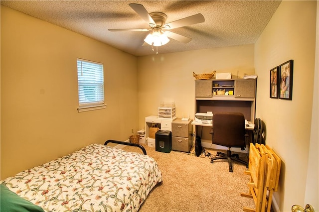 carpeted bedroom featuring a textured ceiling and ceiling fan