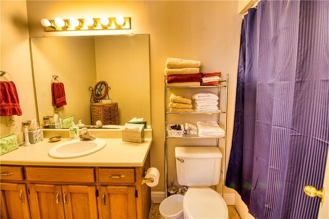 bathroom featuring toilet and vanity