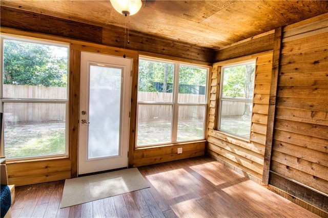 unfurnished sunroom featuring wood ceiling