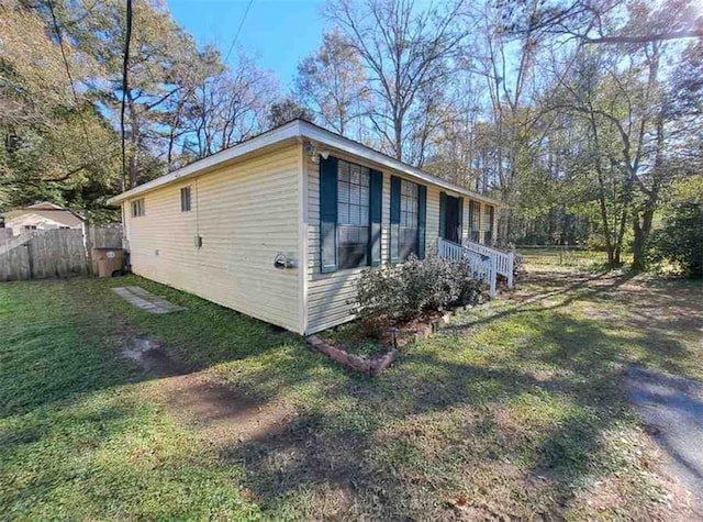 view of side of property with a yard