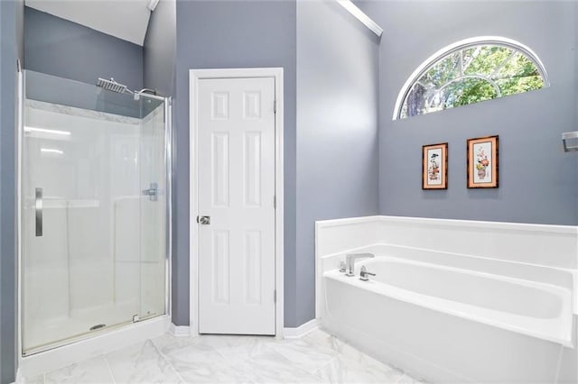 bathroom with a stall shower, baseboards, marble finish floor, and a garden tub