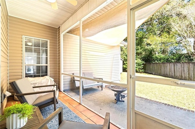 sunroom with plenty of natural light and a ceiling fan