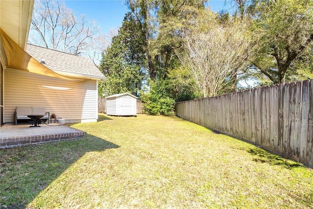 view of yard featuring an outbuilding, a patio, a storage shed, and fence