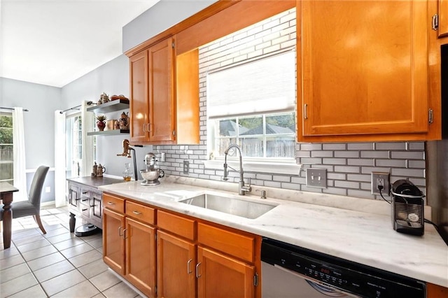 kitchen with tasteful backsplash, dishwashing machine, open shelves, a sink, and light tile patterned flooring