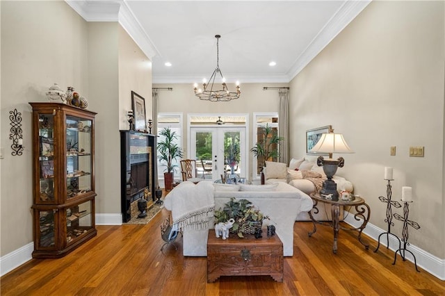 10188 Rosewood Ln, Daphne, AL 36526 - living room featuring french doors, wood finished floors, baseboards, crown molding, and a fireplace