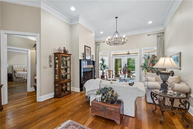 10188 Rosewood Ln, Daphne, AL 36526 - living room featuring a chandelier, wood finished floors, crown molding, recessed lighting, and baseboards