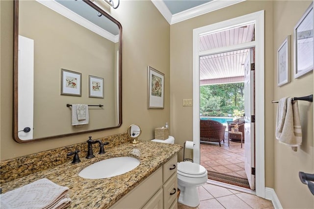 10188 Rosewood Ln, Daphne, AL 36526 - bathroom with crown molding, tile patterned floors, toilet, vanity, and baseboards