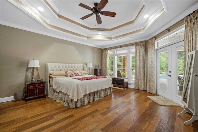 10188 Rosewood Ln, Daphne, AL 36526 - bedroom with ornamental molding, access to exterior, a tray ceiling, french doors, and wood finished floors