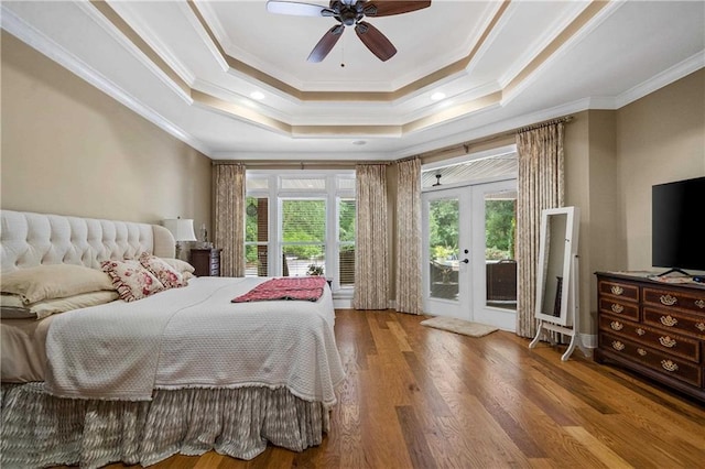 10188 Rosewood Ln, Daphne, AL 36526 - bedroom with access to outside, crown molding, french doors, a tray ceiling, and wood finished floors