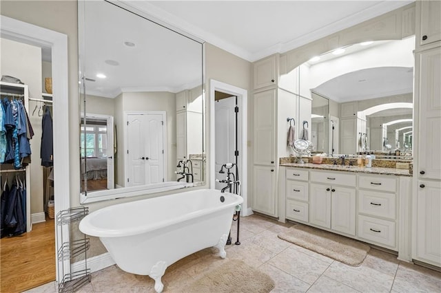 10188 Rosewood Ln, Daphne, AL 36526 - full bathroom featuring ornamental molding, a soaking tub, vanity, a walk in closet, and tile patterned floors