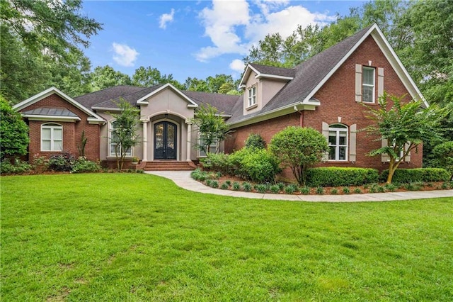 10188 Rosewood Ln, Daphne, AL 36526 - view of front of home with french doors, brick siding, a front lawn, and roof with shingles