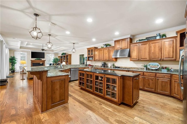 10188 Rosewood Ln, Daphne, AL 36526 - kitchen featuring appliances with stainless steel finishes, under cabinet range hood, brown cabinets, crown molding, and light wood-style flooring