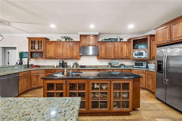10188 Rosewood Ln, Daphne, AL 36526 - kitchen featuring stainless steel appliances, under cabinet range hood, brown cabinets, ornamental molding, and a sink
