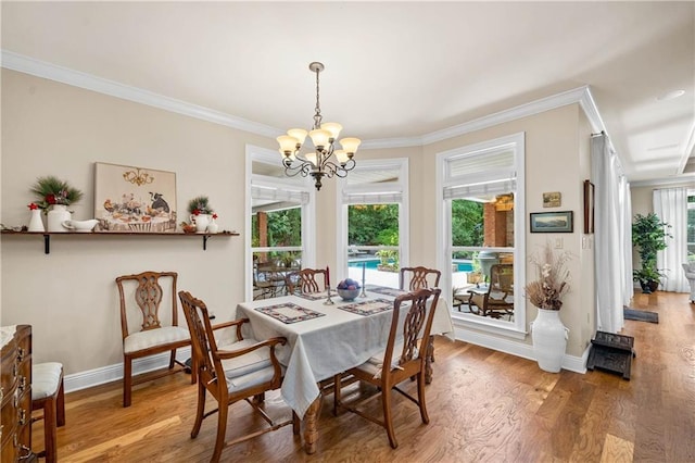 10188 Rosewood Ln, Daphne, AL 36526 - dining area with crown molding, a chandelier, baseboards, and light wood-style flooring