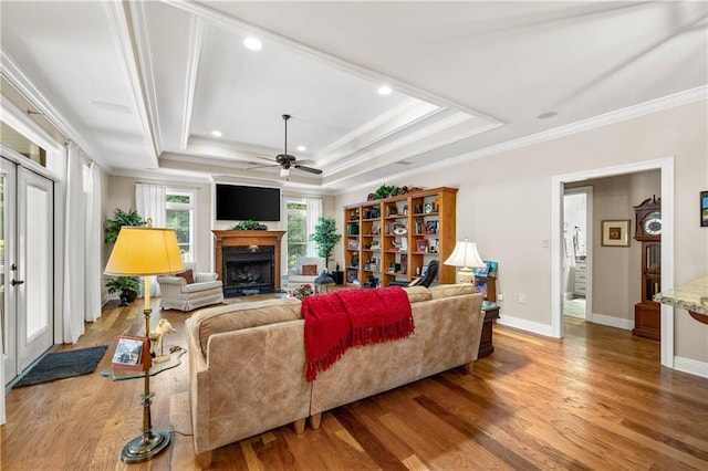 10188 Rosewood Ln, Daphne, AL 36526 - living room with ornamental molding, a tray ceiling, wood finished floors, a fireplace, and ceiling fan
