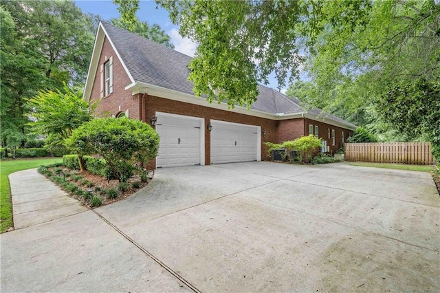 10188 Rosewood Ln, Daphne, AL 36526 - view of home's exterior with brick siding, concrete driveway, an attached garage, and a shingled roof