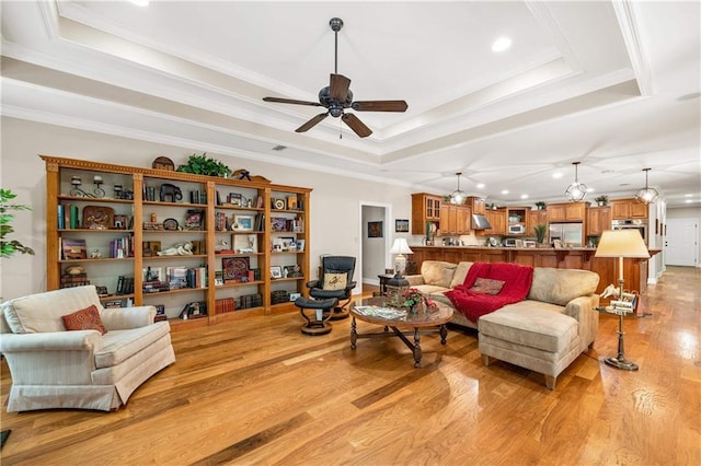 10188 Rosewood Ln, Daphne, AL 36526 - living room with a tray ceiling, light wood-style floors, ceiling fan, recessed lighting, and ornamental molding