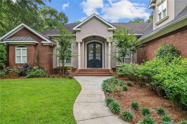 10188 Rosewood Ln, Daphne, AL 36526 - entrance to property with french doors, a yard, brick siding, and a shingled roof