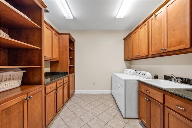 10188 Rosewood Ln, Daphne, AL 36526 - laundry room featuring cabinet space, washing machine and clothes dryer, light tile patterned flooring, and baseboards