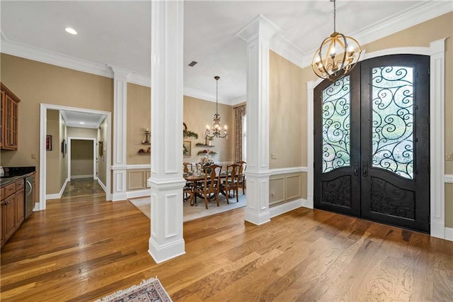 10188 Rosewood Ln, Daphne, AL 36526 - foyer entrance with a chandelier, french doors, light wood-style floors, ornamental molding, and a decorative wall