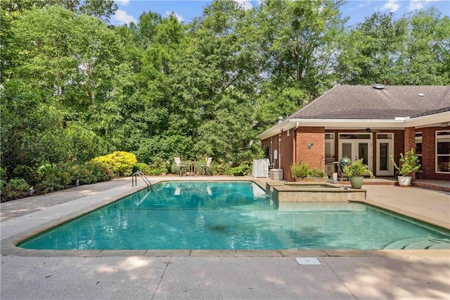10188 Rosewood Ln, Daphne, AL 36526 - outdoor pool featuring a patio, french doors, and view of scattered trees
