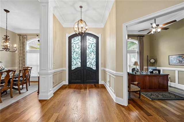 10188 Rosewood Ln, Daphne, AL 36526 - entrance foyer featuring a chandelier, french doors, wood finished floors, a decorative wall, and ornamental molding