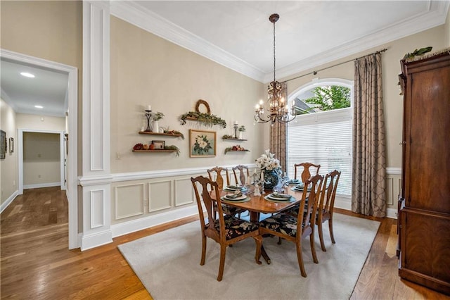 10188 Rosewood Ln, Daphne, AL 36526 - dining room with light wood-style floors, a chandelier, crown molding, and a wainscoted wall