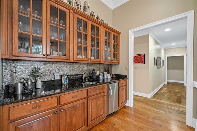 10188 Rosewood Ln, Daphne, AL 36526 - kitchen with a sink, ornamental molding, backsplash, glass insert cabinets, and brown cabinets