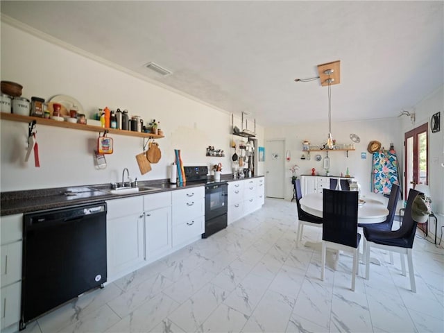 kitchen featuring black appliances, hanging light fixtures, white cabinetry, and sink