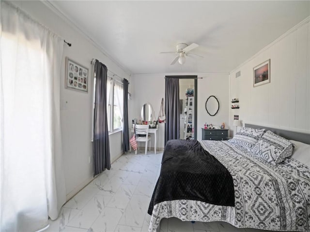 bedroom with ceiling fan and ornamental molding