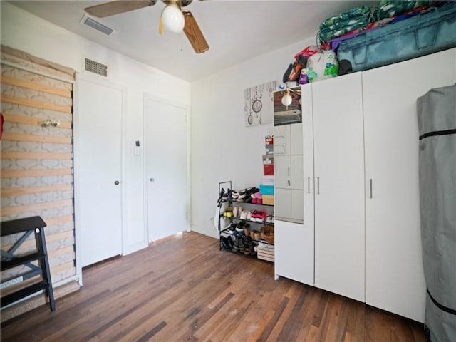 interior space featuring ceiling fan and dark hardwood / wood-style floors