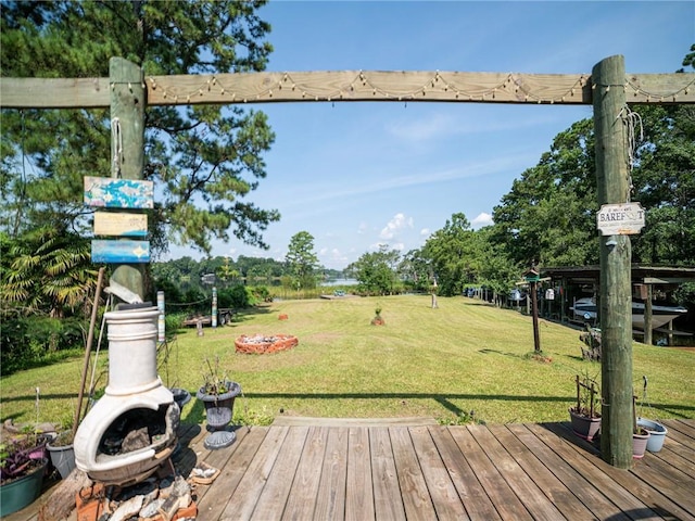 view of yard featuring a deck and a fire pit