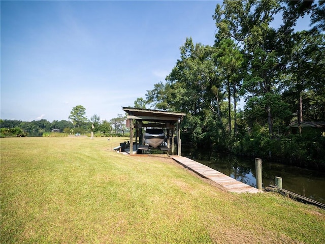 dock area featuring a lawn and a water view