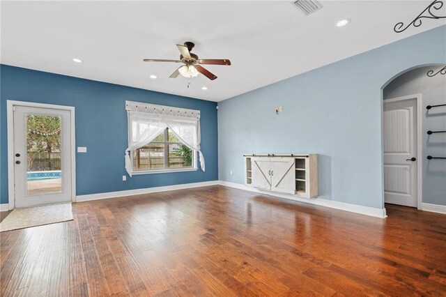 unfurnished living room featuring ceiling fan and hardwood / wood-style flooring