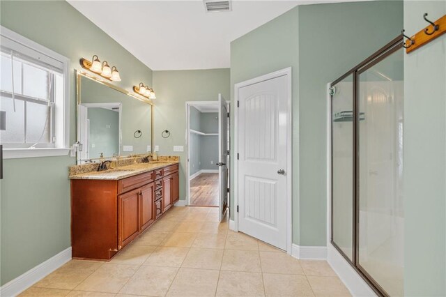 bathroom with tile patterned flooring, an enclosed shower, and vanity