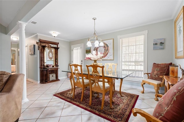 tiled dining room featuring ornamental molding and ornate columns