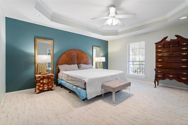 bedroom with crown molding, a tray ceiling, light colored carpet, and ceiling fan