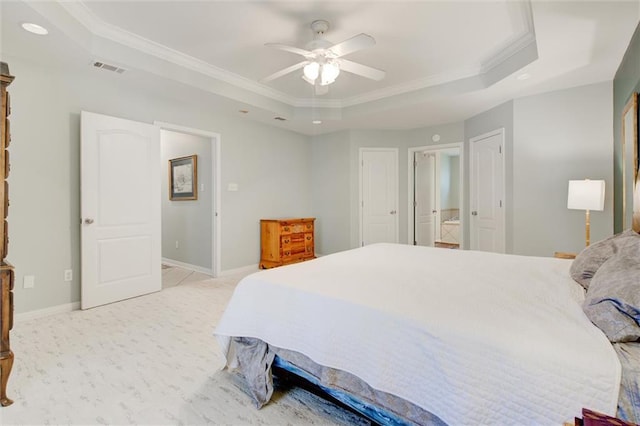 bedroom with ceiling fan, light colored carpet, ornamental molding, and a raised ceiling