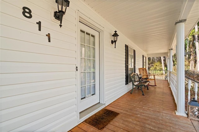 wooden terrace featuring a porch