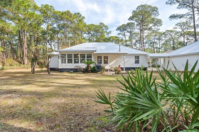 rear view of property with a lawn